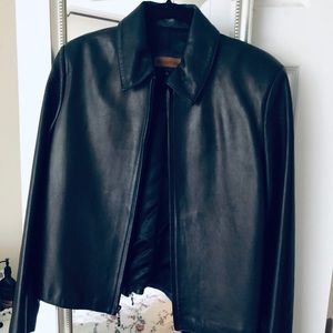 A black Marcel Kassini leather jacket.